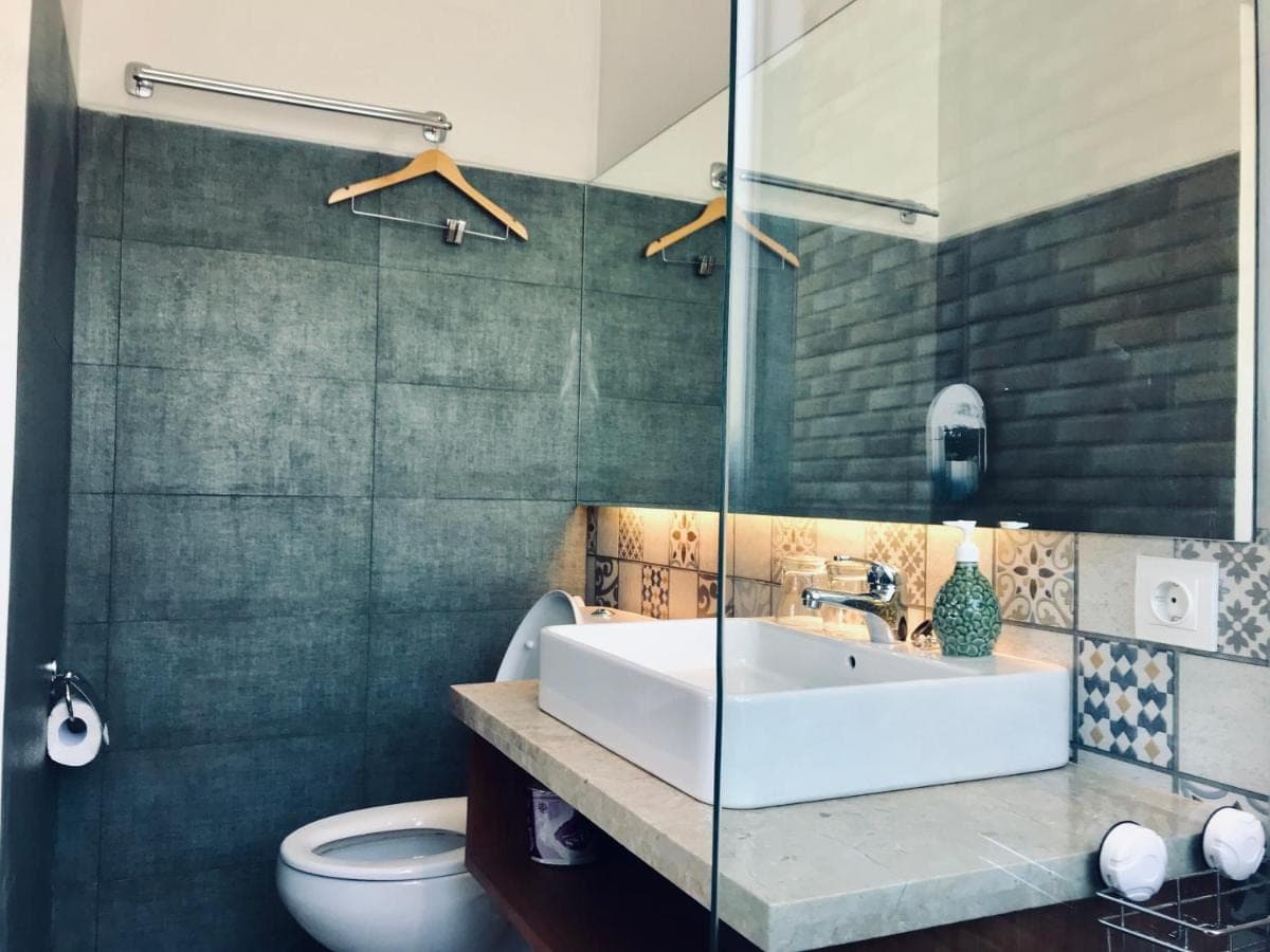 a bathroom with a sink and a toilet at Radha Homestay in Sanur