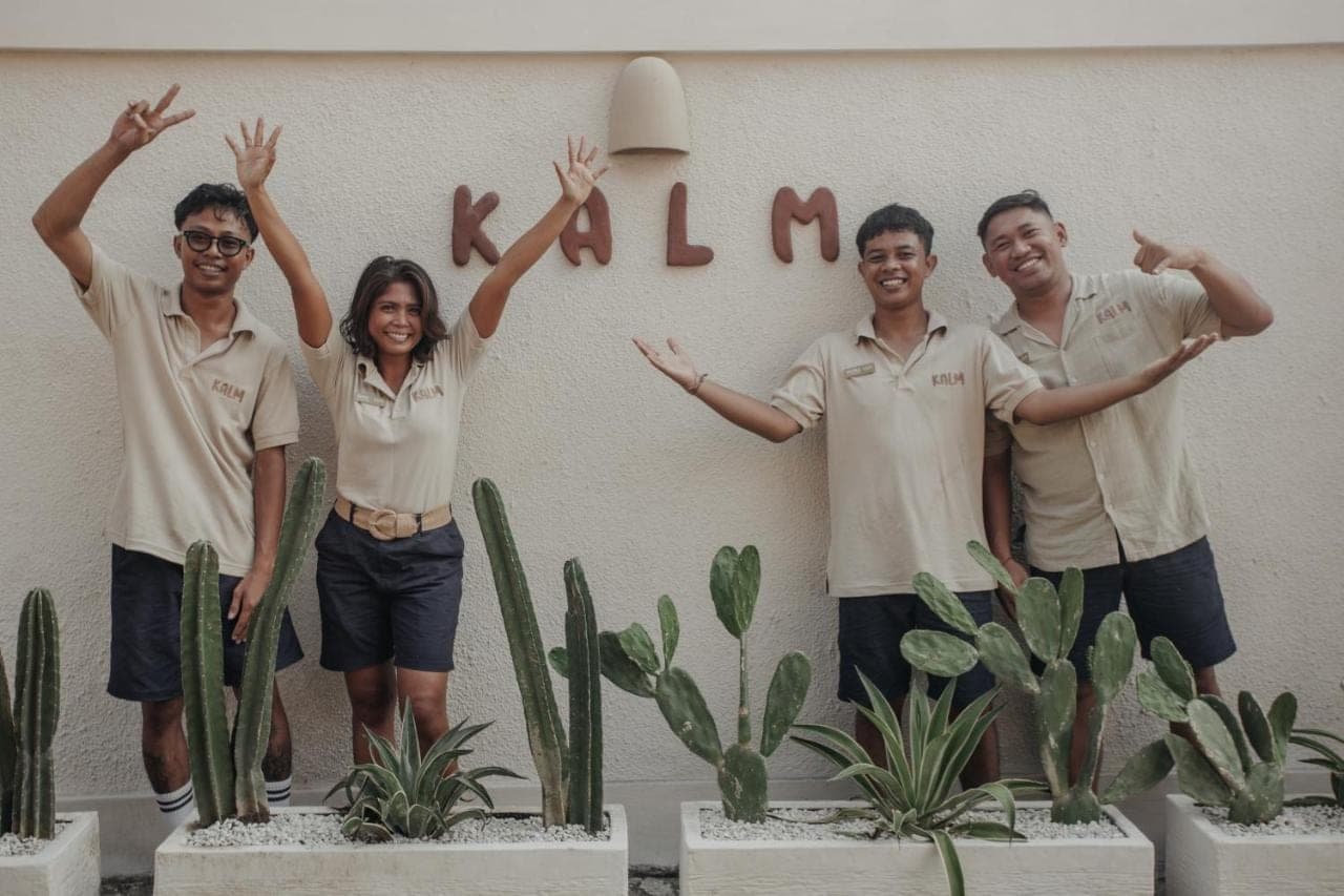 a group of people standing in front of a wall at KALM Bali in Canggu