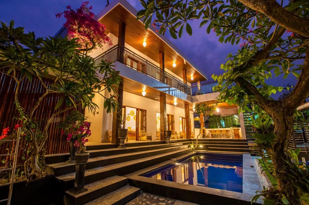 an exterior view of a house with a swimming pool at The Nest Canggu in Canggu