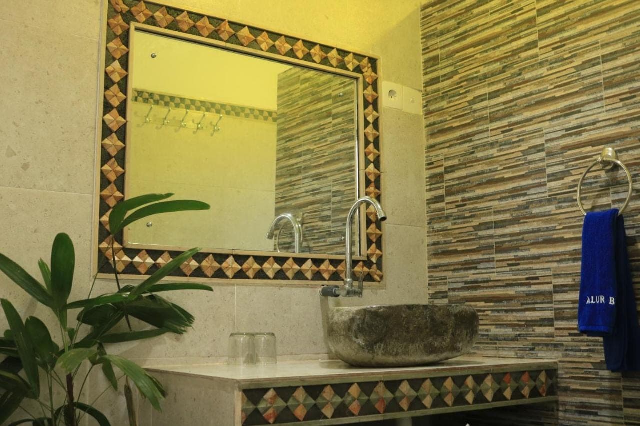 a bathroom with a sink and a mirror at Alur Beach Homestay in Amed