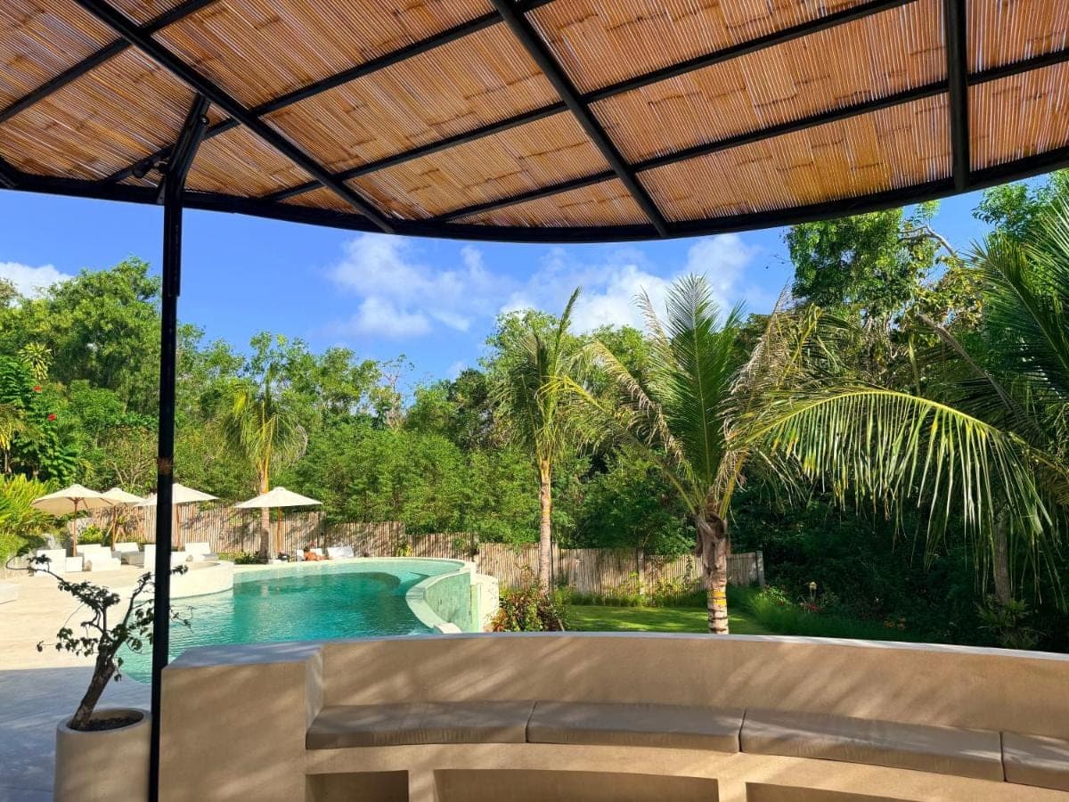 a view of the pool from the patio of a resort at Tregge Surf Camp Uluwatu in Uluwatu