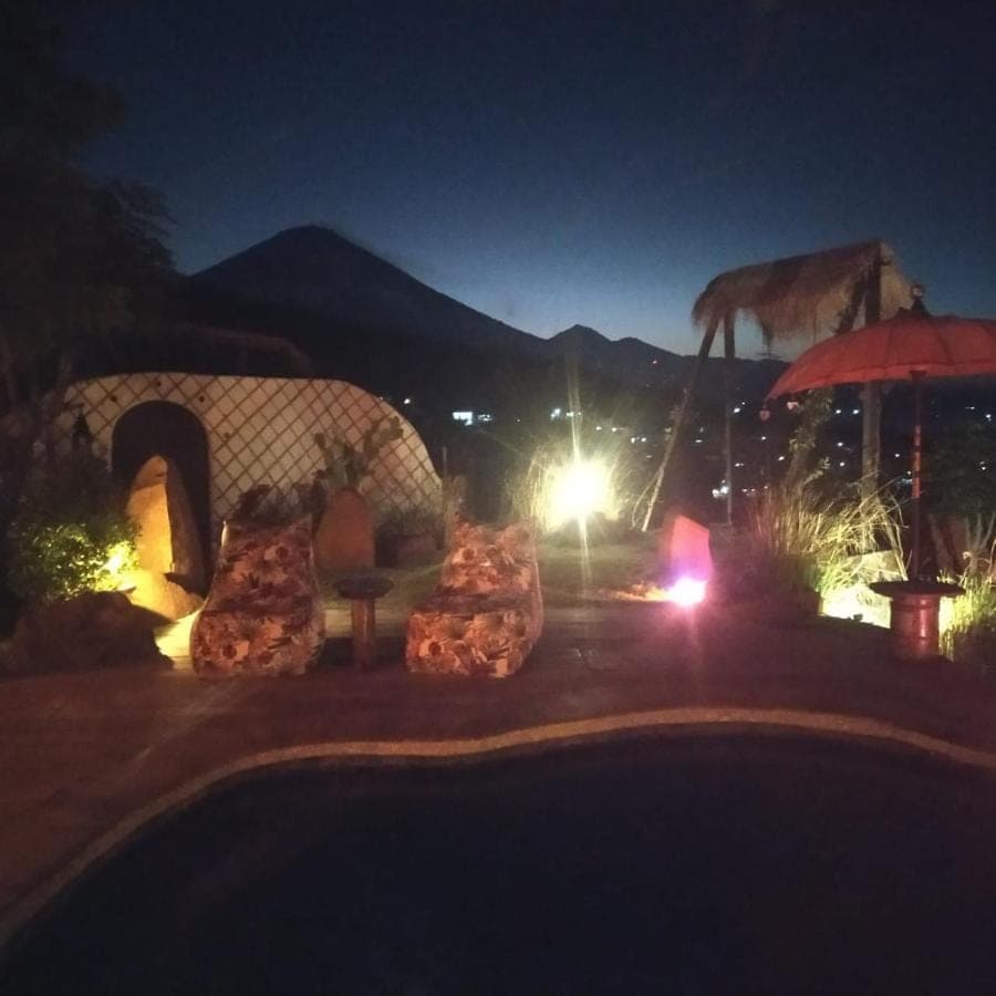a night view of a patio with a fire place at Blue Earth Village in Amed