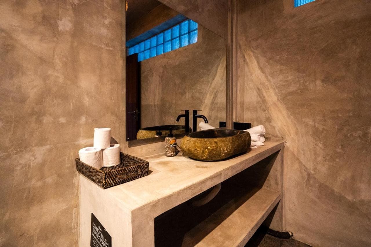 a bathroom with a sink and a mirror at Padawatu Villas in Uluwatu