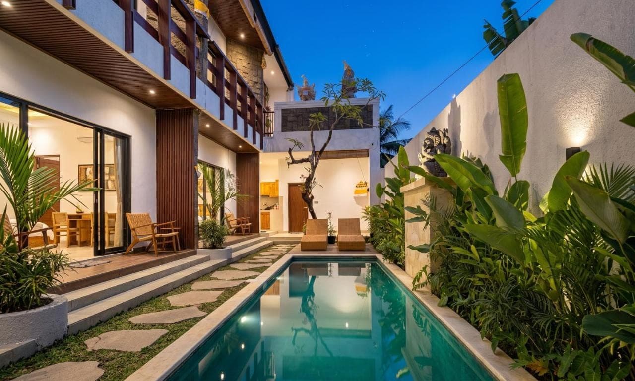an indoor swimming pool in the backyard of a house at Umah Delod Ubud in Ubud