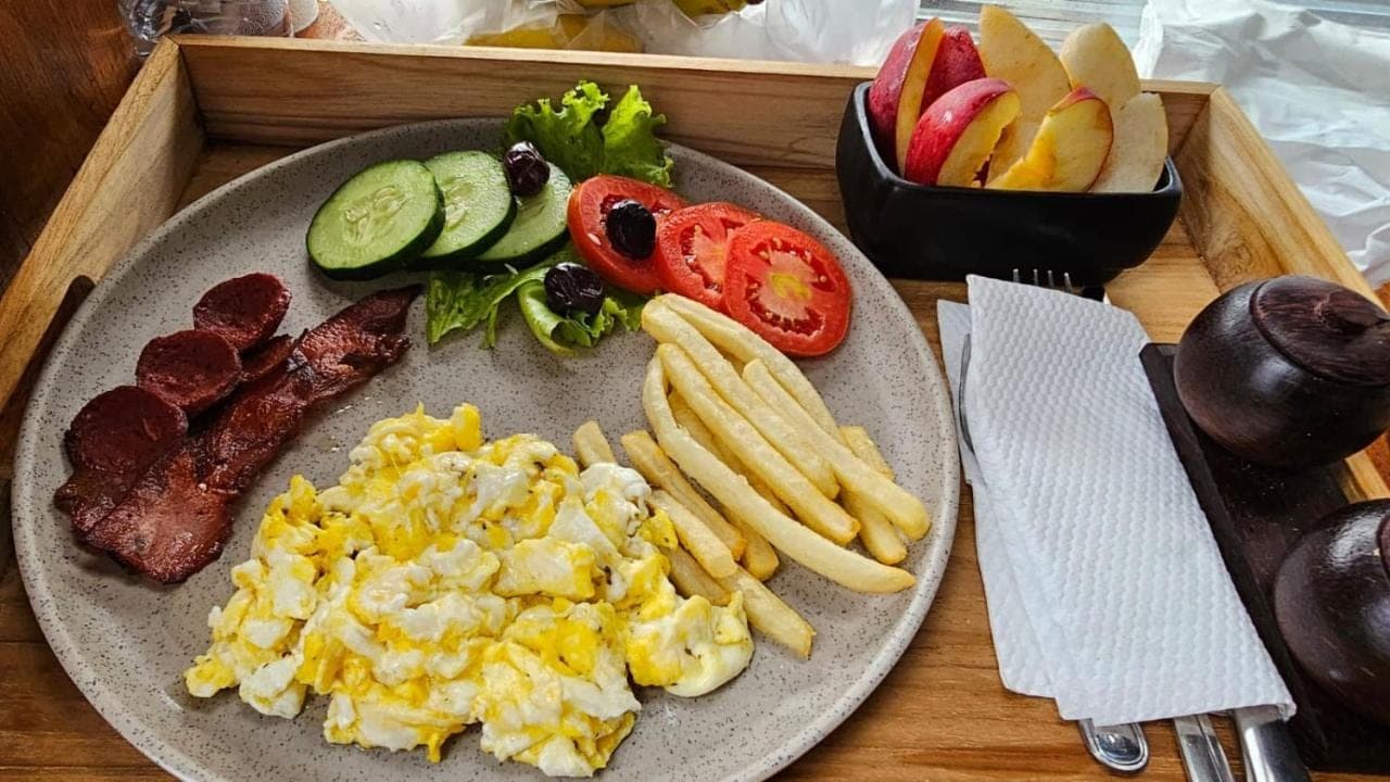 a plate of food with scrambled eggs and french fries at Mai Mucuk Lumbung in Canggu
