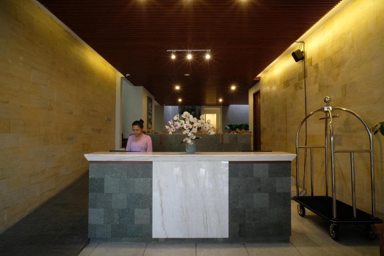 a woman standing at a counter in a room at The Ledge Uluwatu in Uluwatu