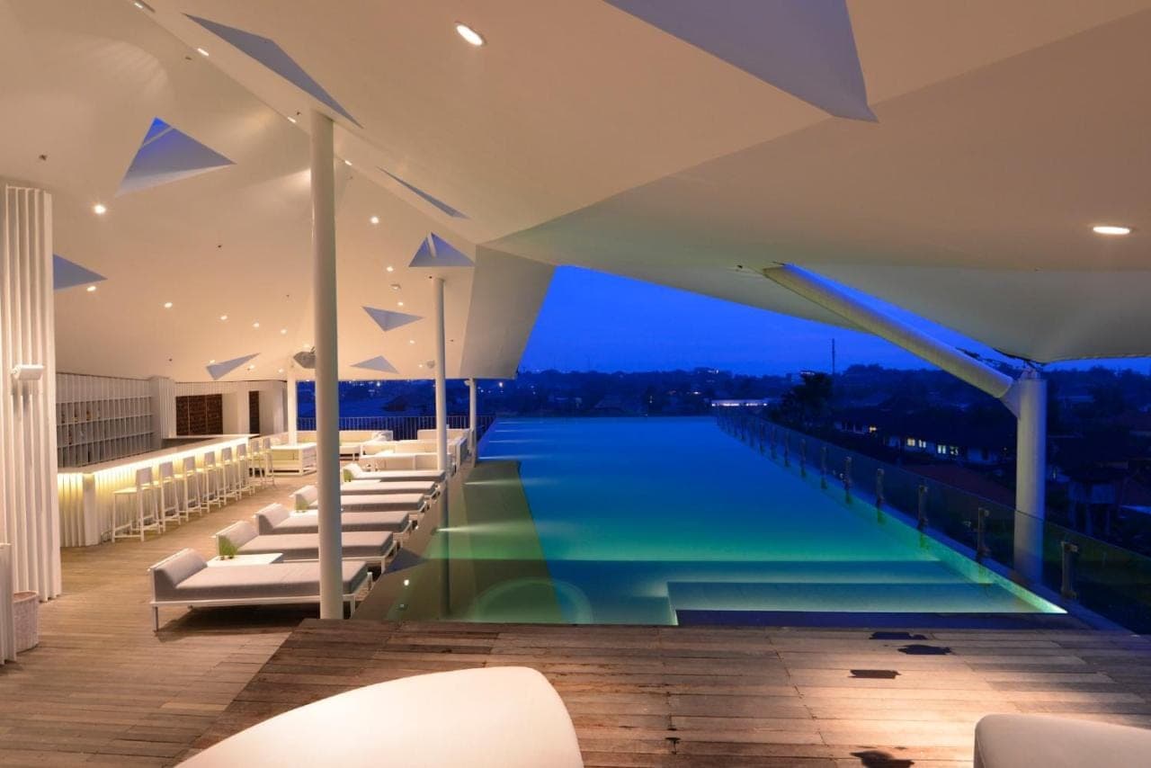 a swimming pool on the roof of a building at IZE Seminyak by LifestyleRetreats in Seminyak