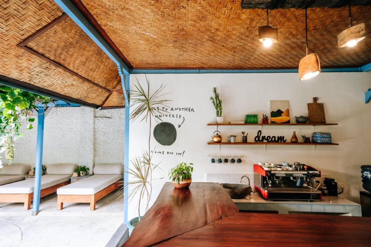 a room with a wooden table and a stove at Sanur House in Sanur
