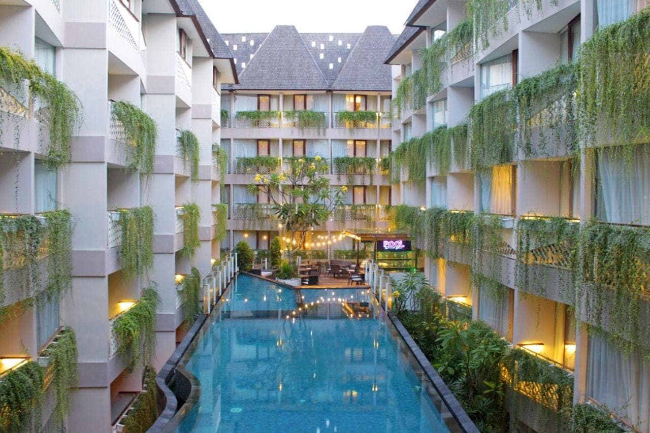 an indoor pool in the courtyard of a hotel at Episode Kuta Bali in Kuta