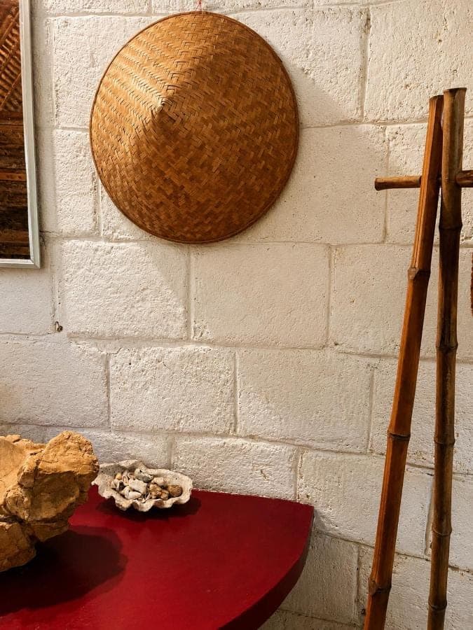 a wall with a basket and a red table at Vertical House Bali in Uluwatu