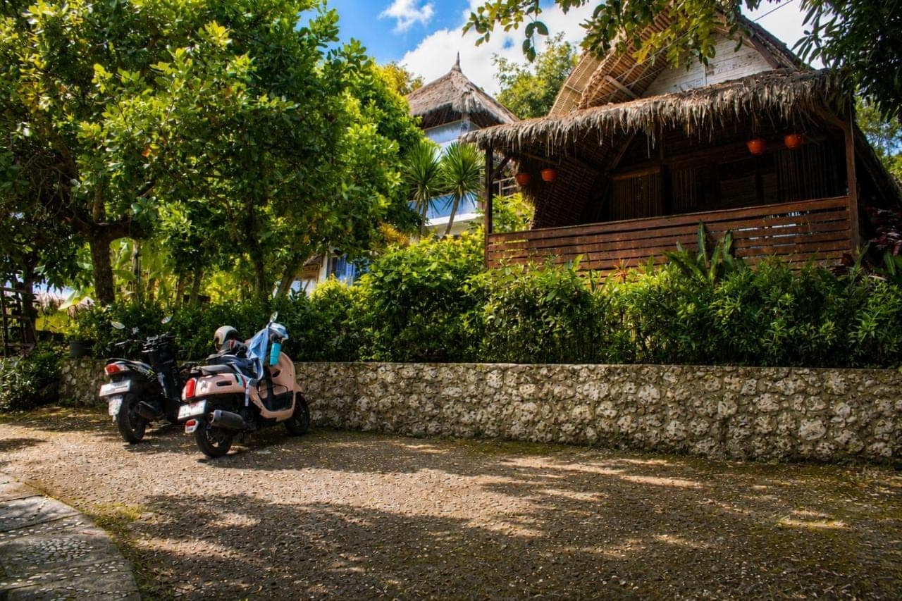 a motorcycle parked in front of a house at Vertical House Bali in Uluwatu