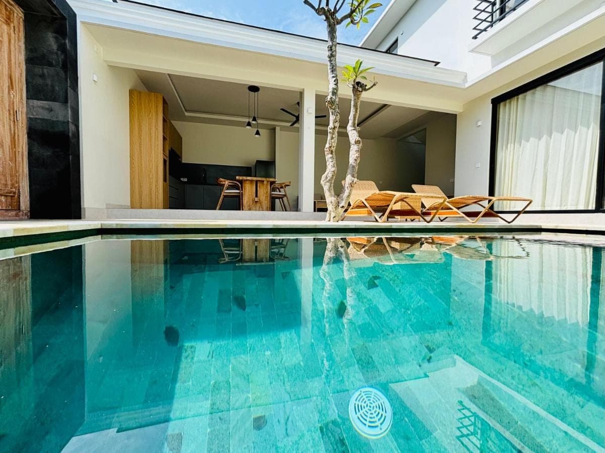 a swimming pool with blue water in a house at Lipah Beach Private Villas in Amed
