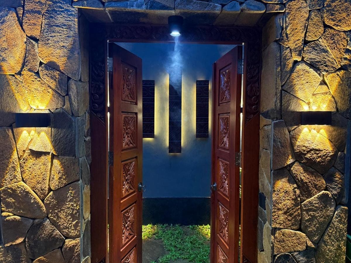an open door to a house at night at Kankhara Villas Sidemen in Sidemen