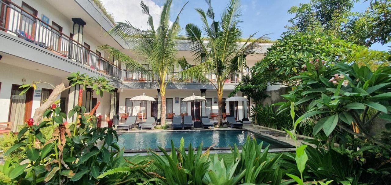 an exterior view of a villa with a swimming pool at Surf Lodge Canggu in Canggu