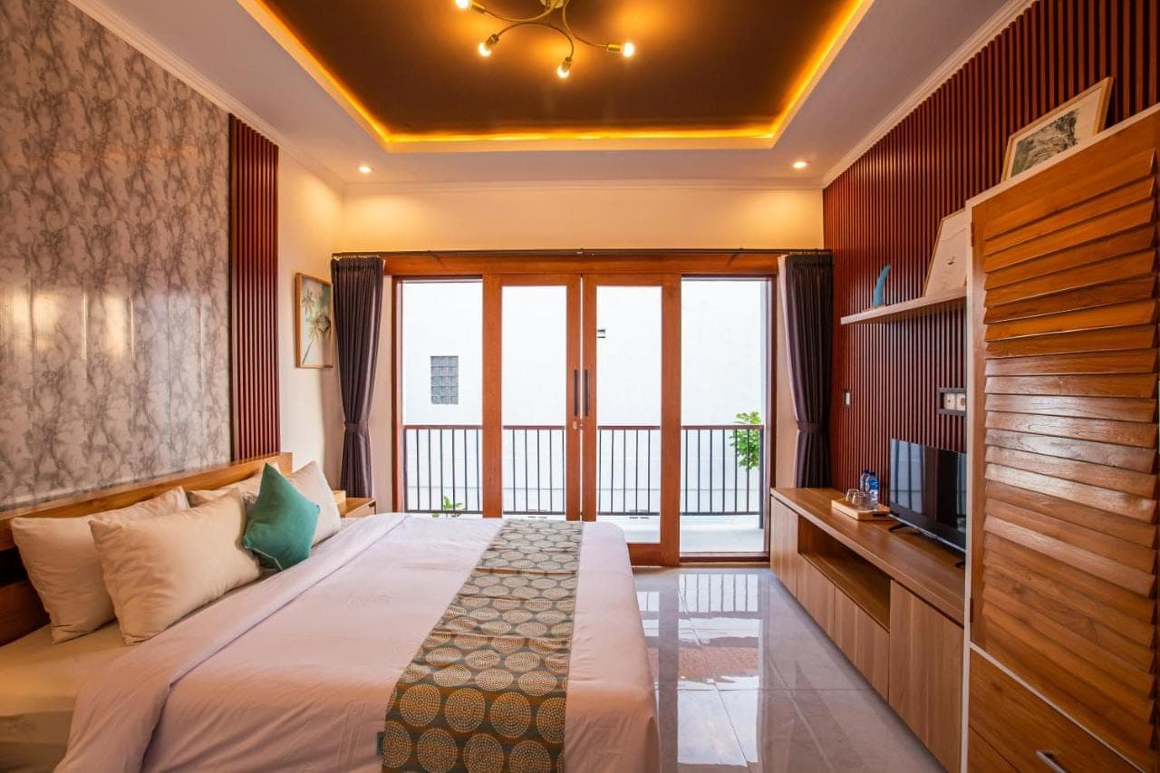 a bedroom with a bed and a large window at Surf Lodge Canggu in Canggu