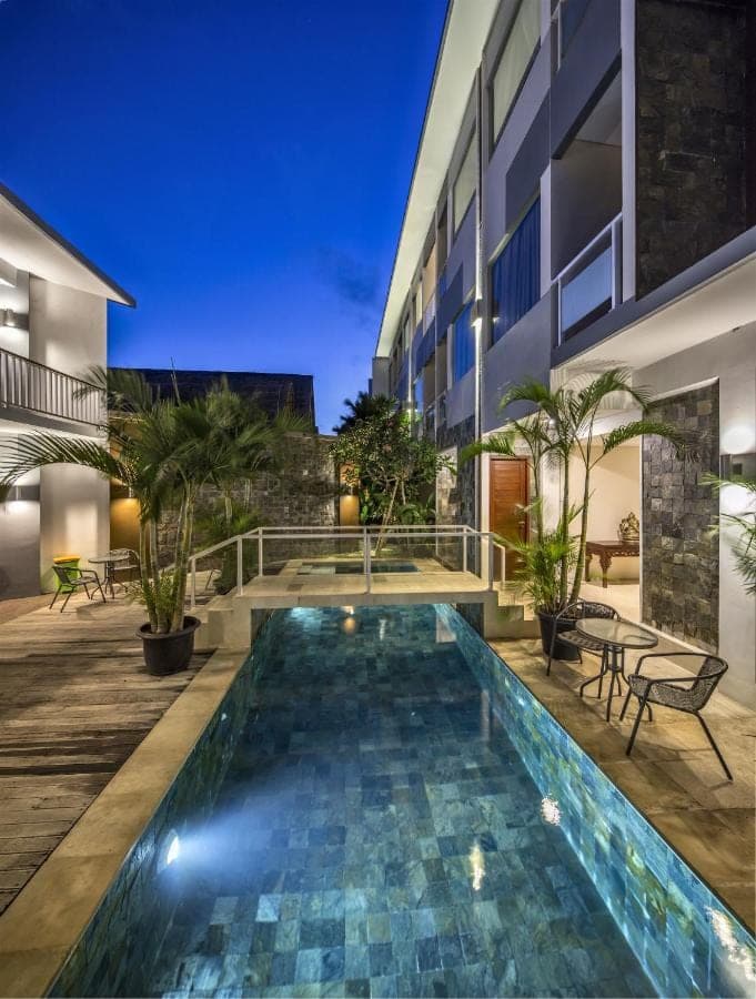 a swimming pool in front of a building at M Suite Bali in Seminyak