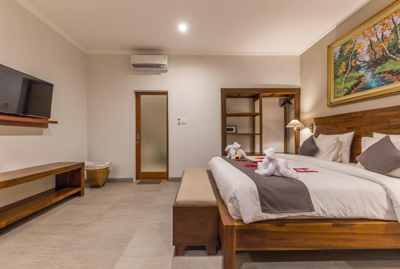 a bedroom with a bed with two stuffed animals on it at Soki Villa in Canggu