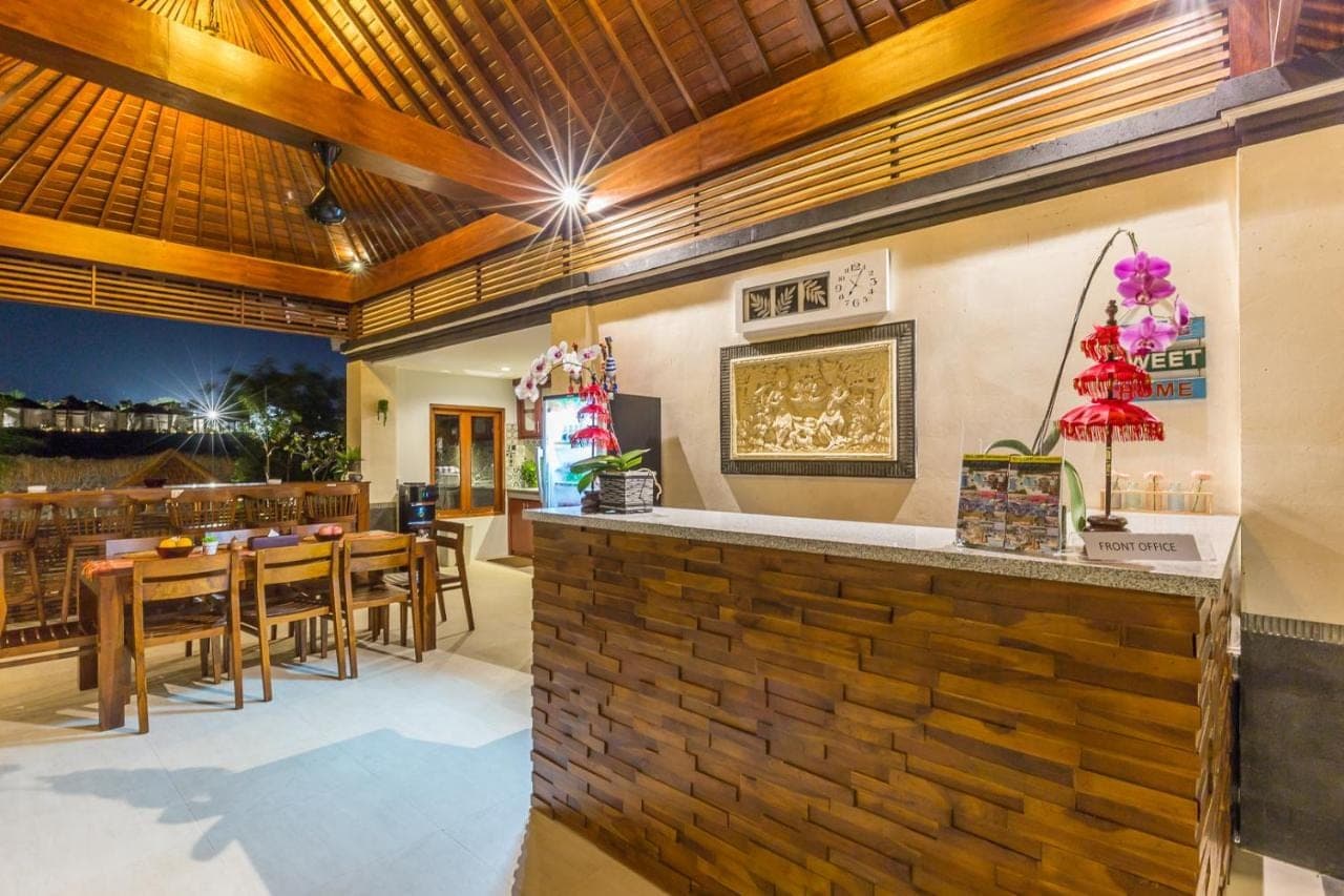 a kitchen and dining room with a brick wall at Soki Villa in Canggu