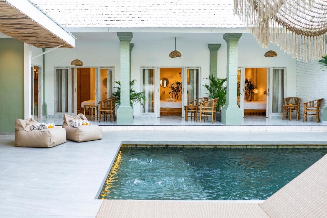 a house with a swimming pool and a patio at Eden Garden Villa Canggu in Canggu