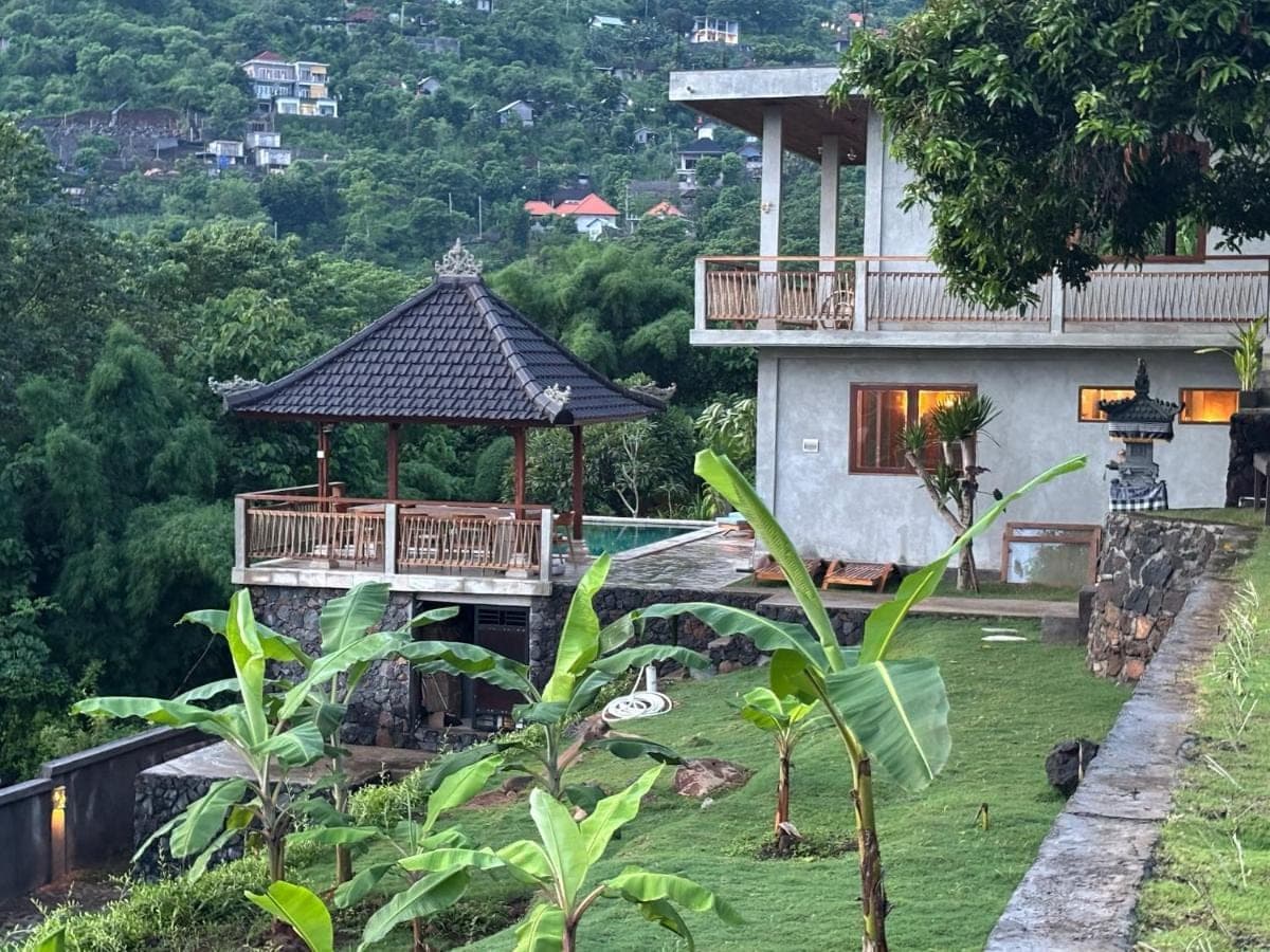 a house with a gazebo in front of it at First Light Villa at Lipah Beach, Amed in Amed