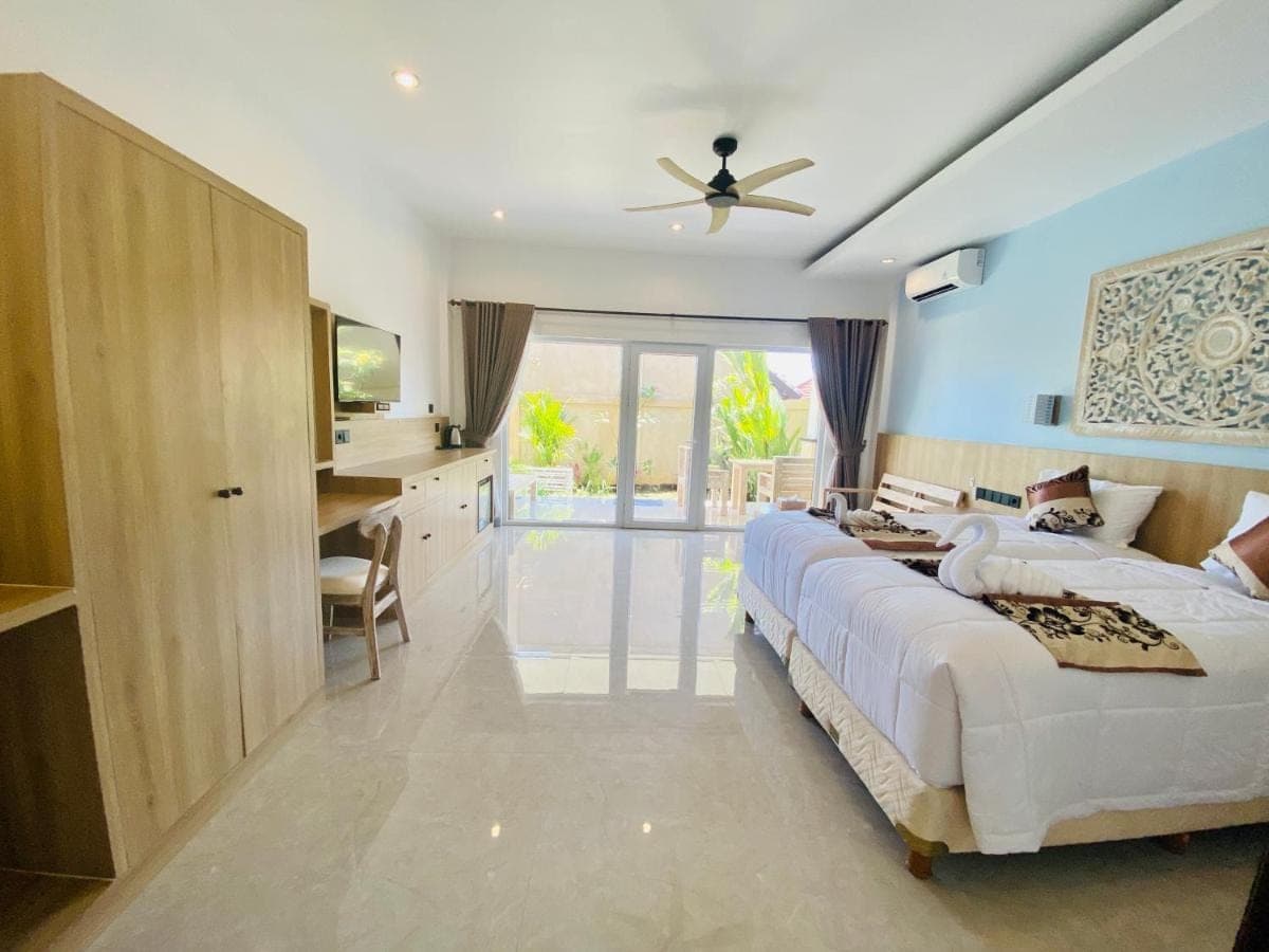a large bedroom with a large bed and a kitchen at Solaluna Beach Homestay in Amed