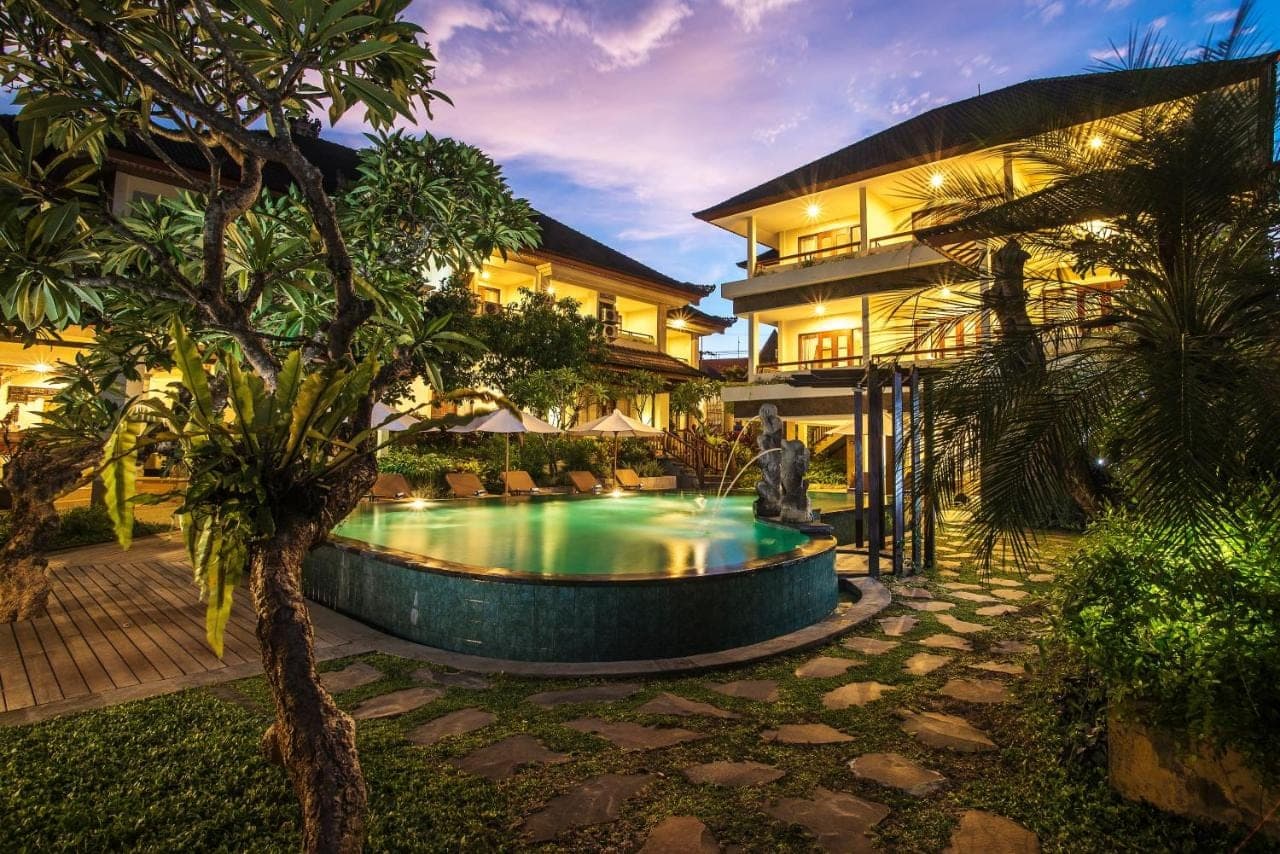 a house with a swimming pool in front of a building at Sri Phala Resort &amp; Villa in Sanur