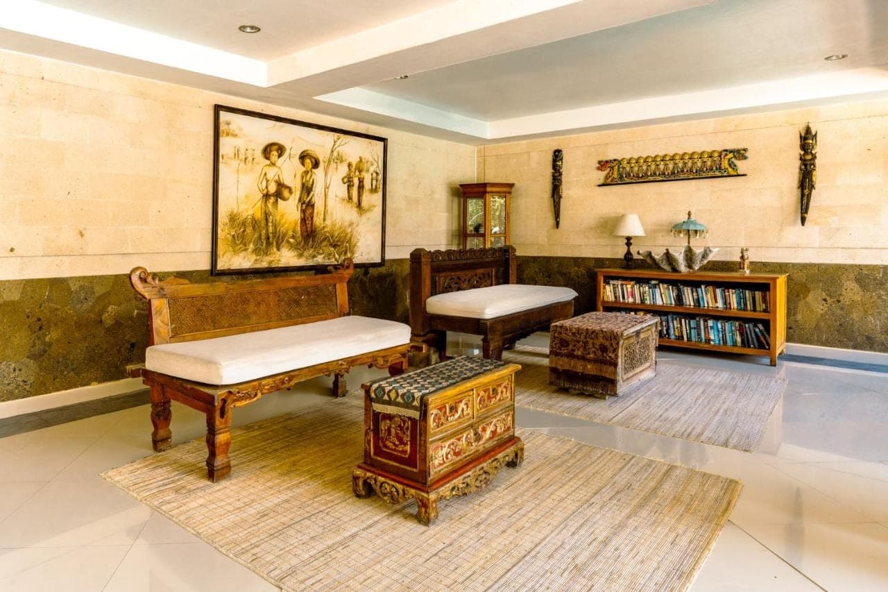 a living room filled with furniture and a table at Sri Phala Resort &amp; Villa in Sanur