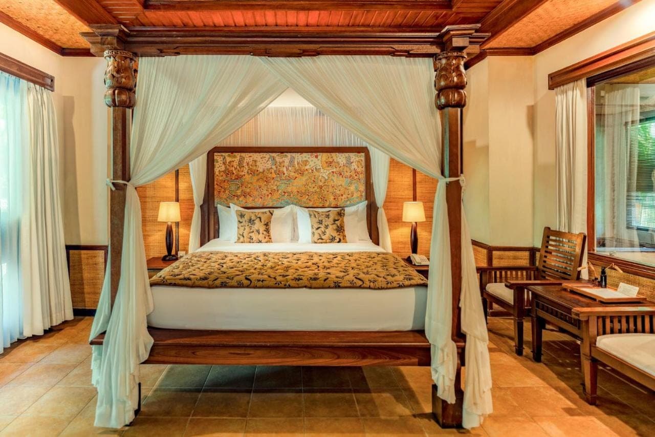 a bedroom with a canopy bed in a room at Sri Phala Resort &amp; Villa in Sanur