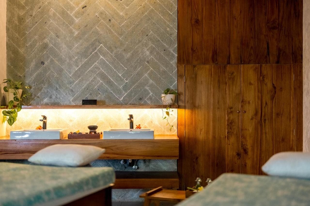a bathroom with two sinks and a mirror at Sri Phala Resort &amp; Villa in Sanur