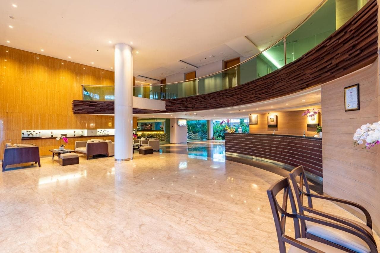 a lobby of a hotel with a staircase at Bintang Kuta Hotel in Kuta