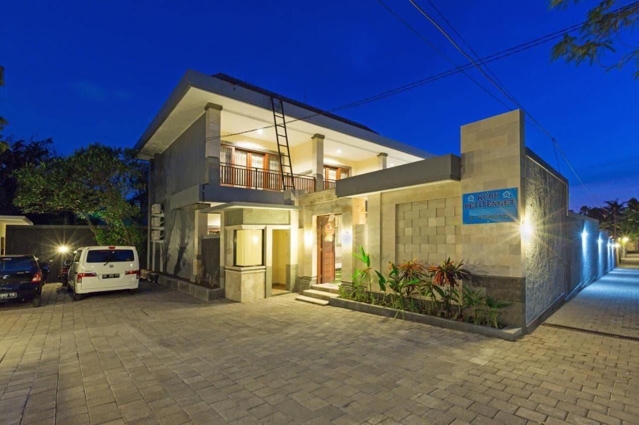a white van parked in front of a house at night at Kubu Petitenget Suite Seminyak in Seminyak