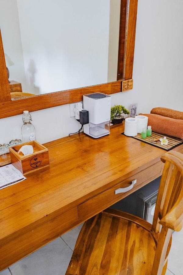 a wooden counter top with a mirror on it at Kayuma House Canggu in Canggu