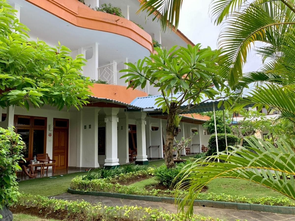 a house with trees in front of it at Febri's Hotel &amp; Spa in Kuta