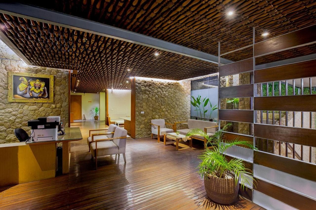 a lobby with a waiting room with tables and chairs at THE HAVEN Bali Seminyak in Seminyak