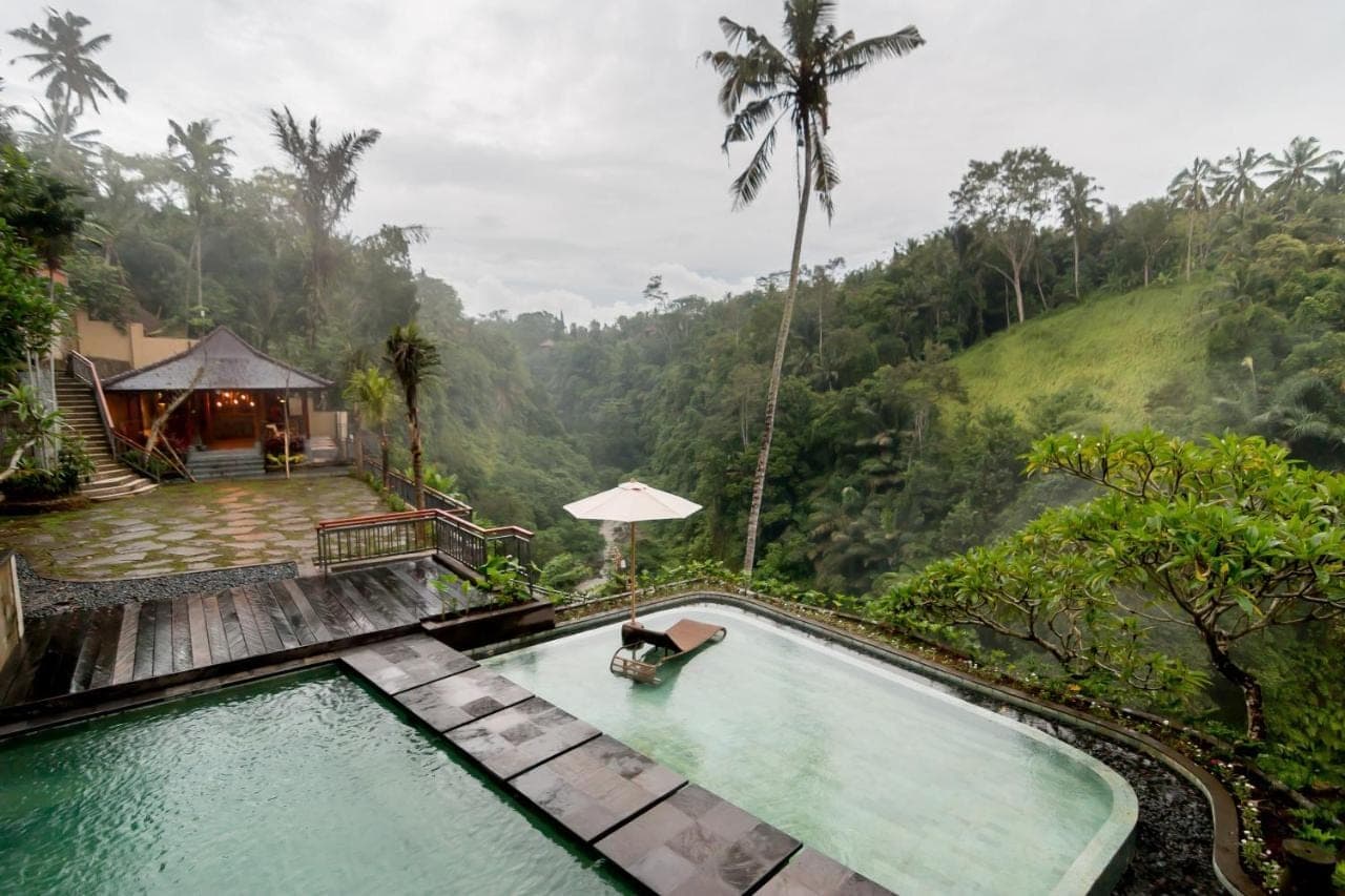 a swimming pool with a view of a mountain at Ulun Ubud Resort &amp; Spa in Ubud