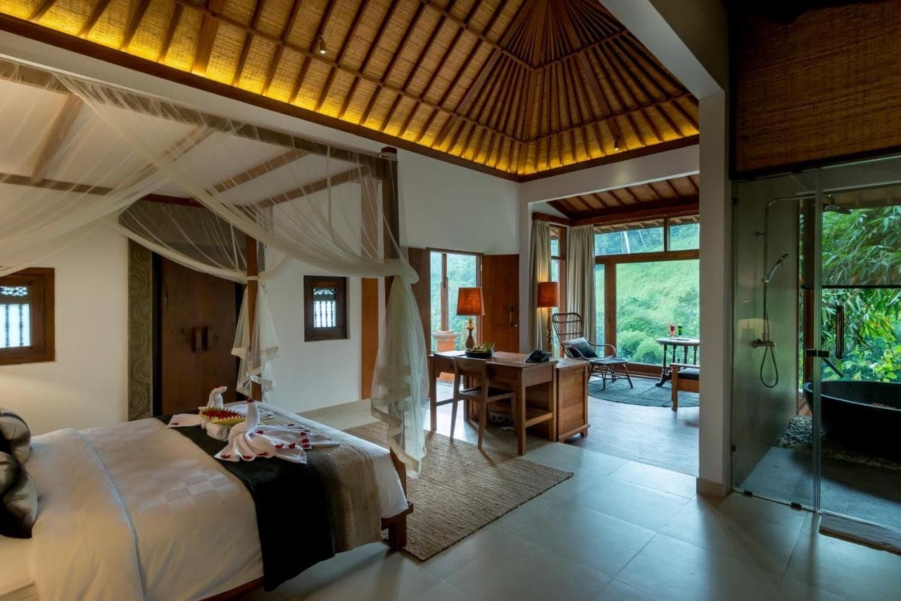 a bedroom with a large bed and a bathroom at Ulun Ubud Resort &amp; Spa in Ubud
