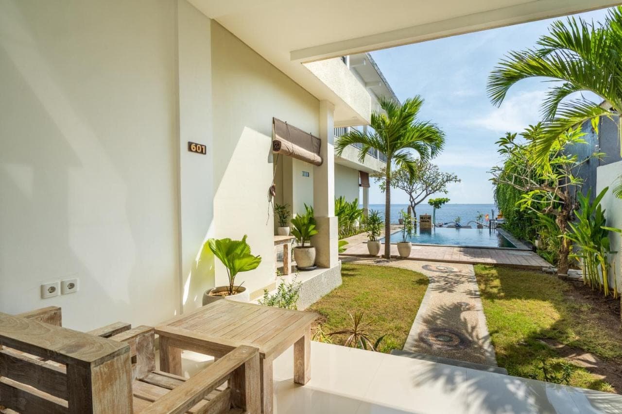 a view of the ocean from the balcony of a house at Mejore Beach Hotel in Amed