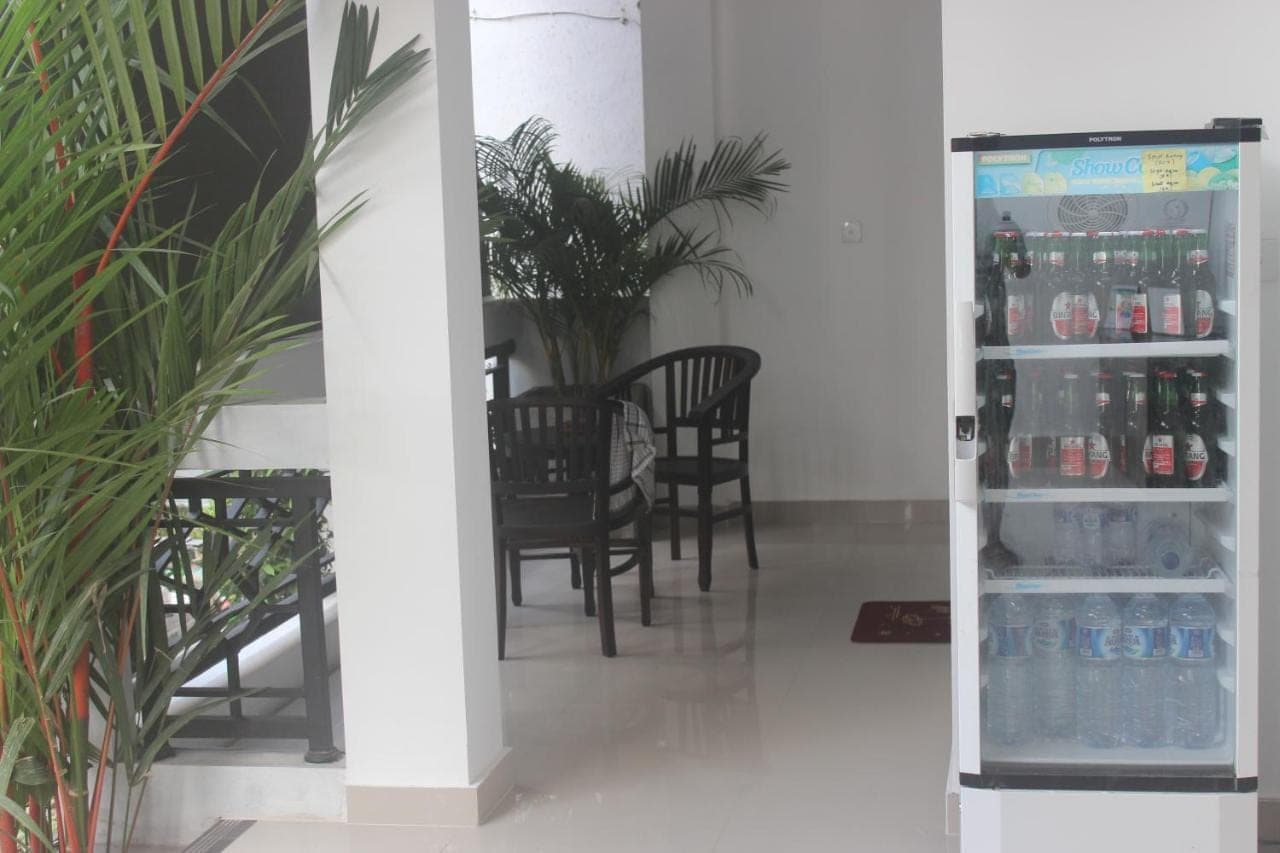 a refrigerator filled with drinks in a dining room at Silvy Guesthouse in Canggu