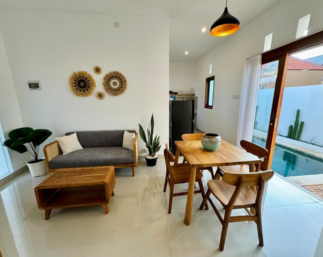 a living room with a table and a couch at Lily House Cozy 2 bedrooms Villa with Pool in Bukit in Nusa Dua
