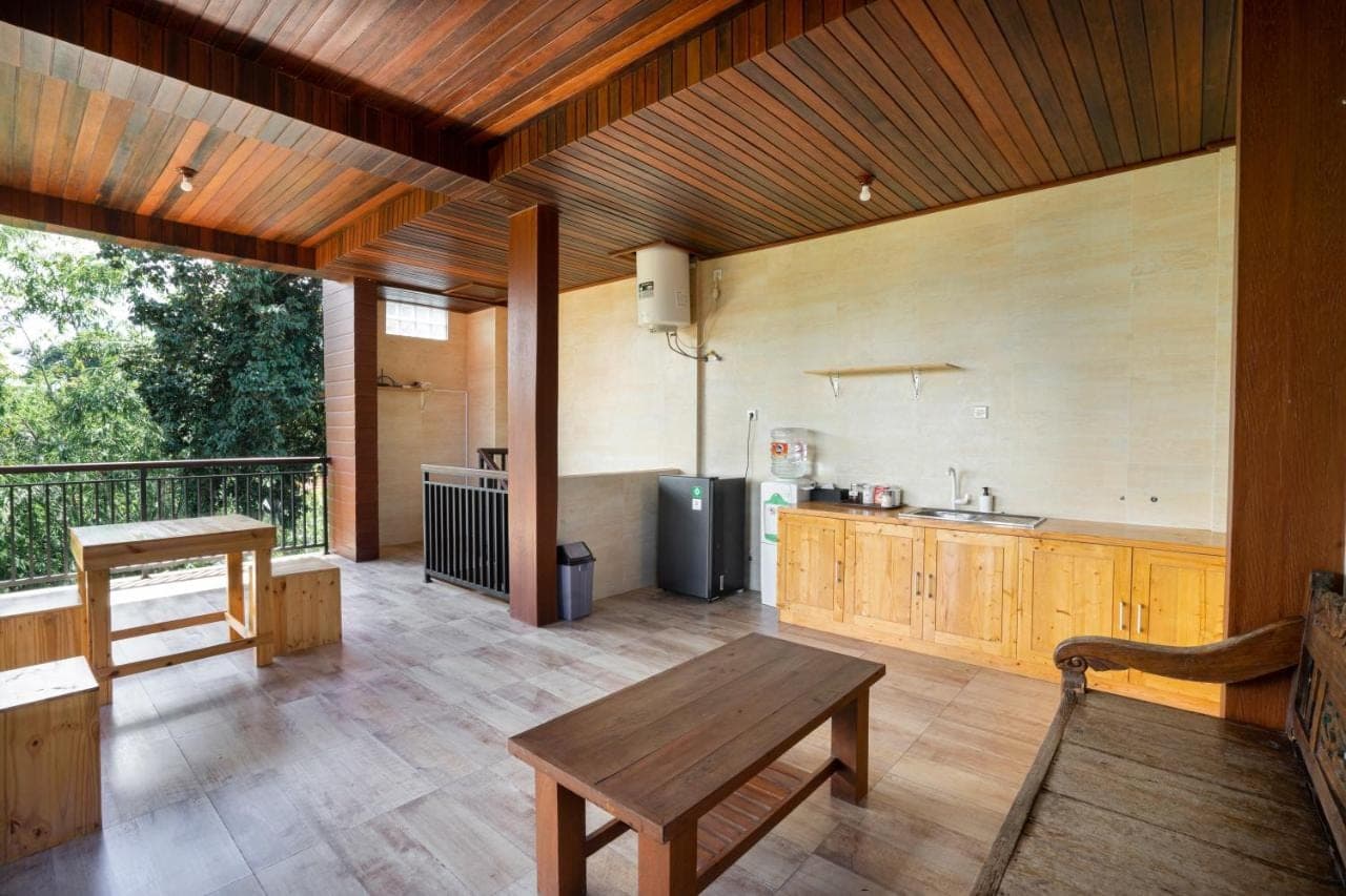 a large kitchen with a table and a counter at K Hostel Seminyak in Seminyak