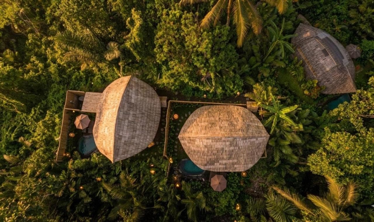 an overhead view of a resort with umbrellas in trees at Phoenix Bamboo House by Ecobreeze in Sidemen