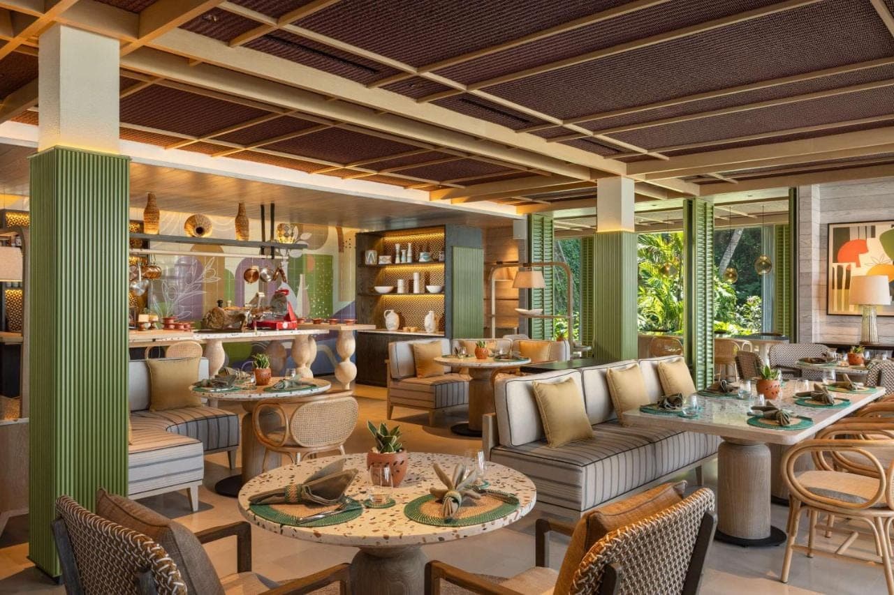 a restaurant with couches and tables and chairs at Hilton Bali Resort in Nusa Dua
