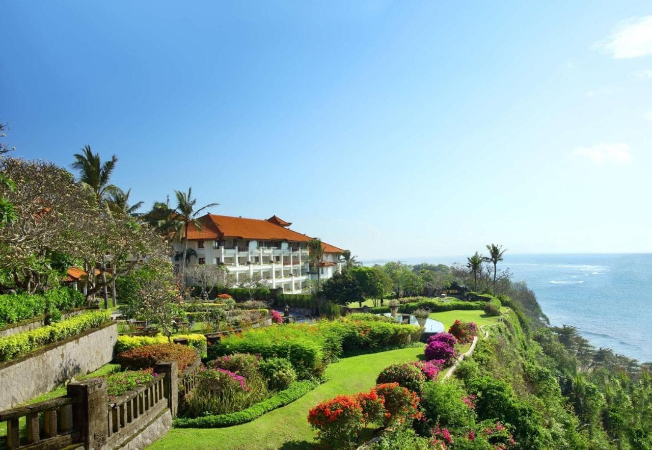 a view of a resort with flowers and the ocean at Hilton Bali Resort in Nusa Dua