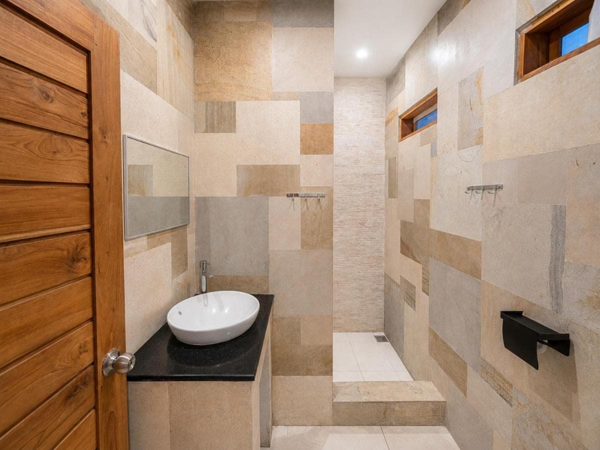a bathroom with a sink and a toilet in it at Surf Bali Villa in Uluwatu