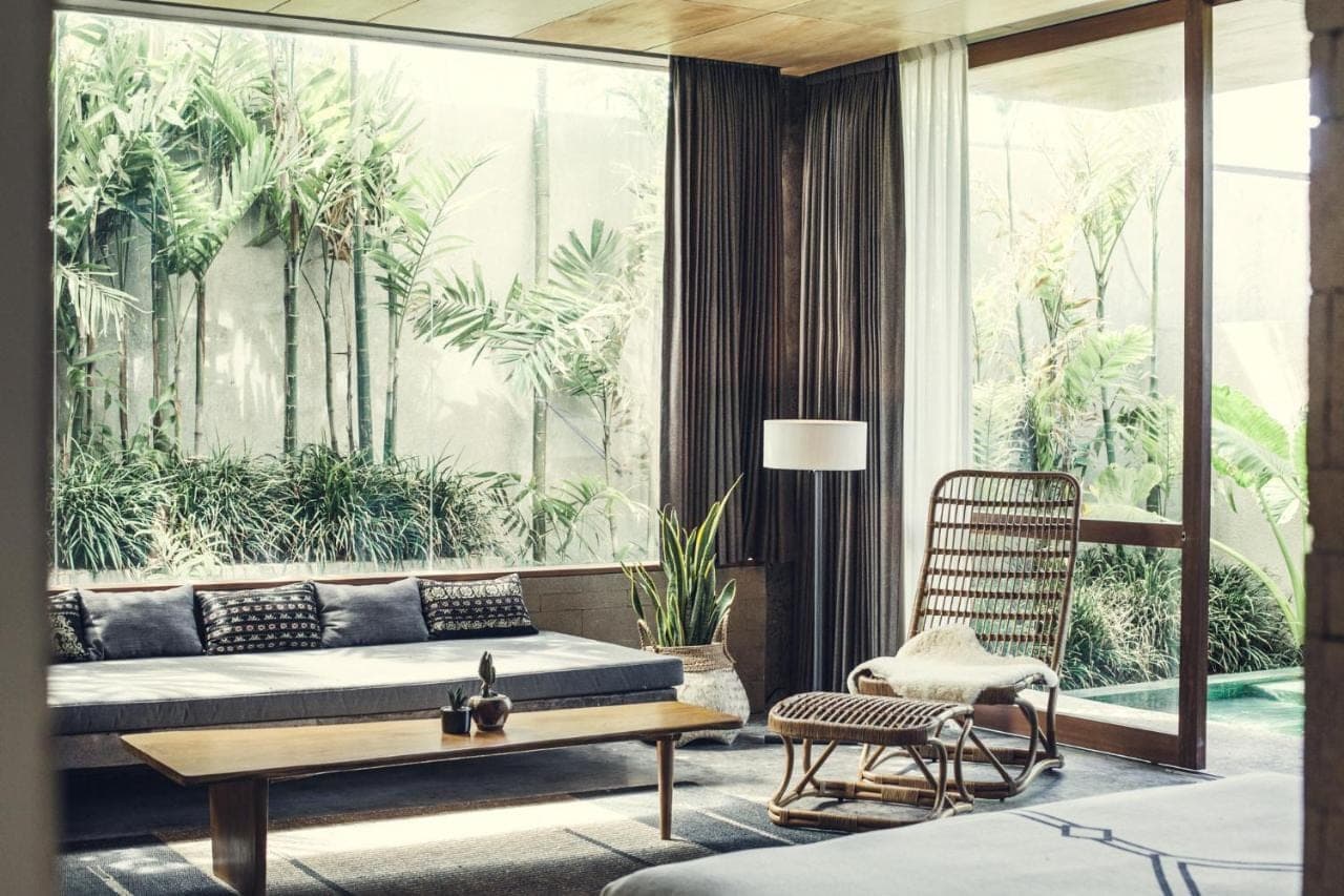 a living room with a couch and a chair at The Slow Canggu in Canggu