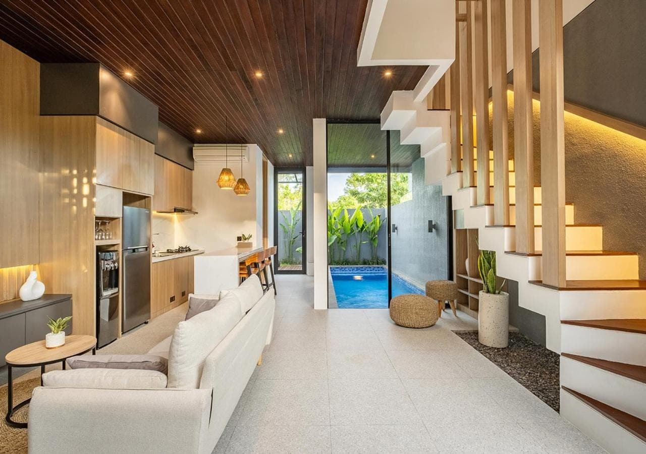 a living room with a white couch and a staircase at Private Villa Ayra 8B by OriVista 10min to Melasti Beach in Uluwatu