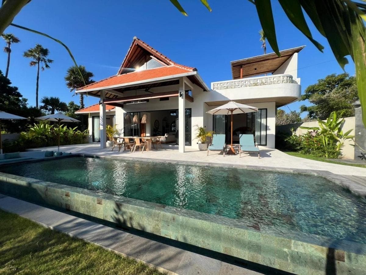 a house with a swimming pool in front of a house at Villa Naga\u00efa - Private Pool, Rooftop &amp; Agung Views in Amed