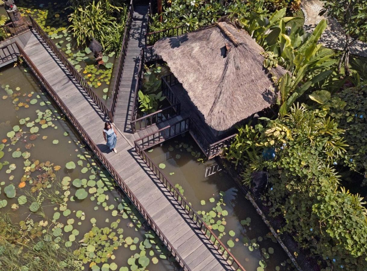 a model of a building with a woman walking on a train track at Hotel Tugu Bali, Canggu in Canggu
