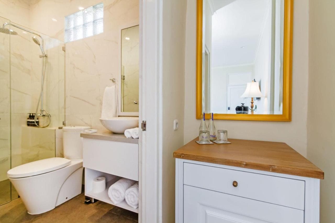 a bathroom with a toilet and a sink and a shower at Akaya Bali in Sanur