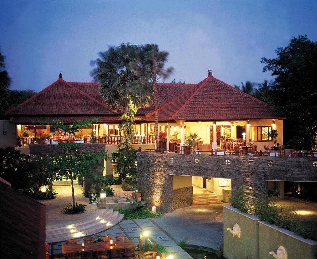 a building with a courtyard with a restaurant at AlamKulkul Boutique Resort in Kuta